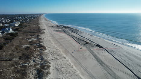 Drone-shot-of-beach-nourishment,-or-adding-sand-or-sediment-to-beaches-to-combat-erosion,-can-have-negative-impacts-on-wildlife-and-ecosystems,-wide-aerial-shot