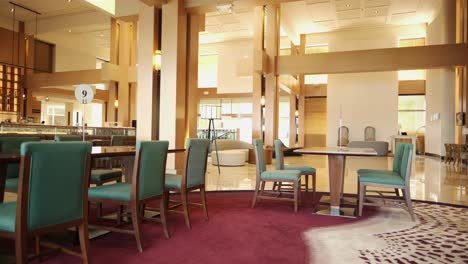 Static-wide-shot-of-empty-dining-area-and-lobby-interior-in-posh-luxury-hotel-in-Guam