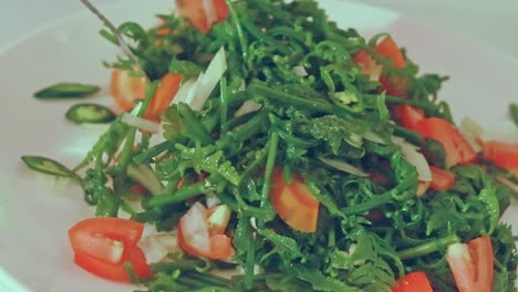 Close-up-to-a-fiddlehead-fern-salad-or-pako-salad-being-tossed,-an-authentic-traditional-Filipino-dish-from-the-Philippines