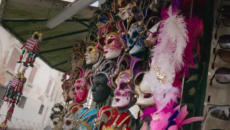 Exquisite-feathered-Venetian-masks-stand,-Venice-Italy