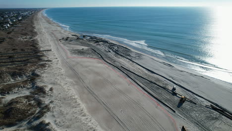 Drone-shot-of-beach-nourishment,-or-adding-sand-or-sediment-to-beaches-to-combat-erosion,-can-have-negative-impacts-on-wildlife-and-ecosystems