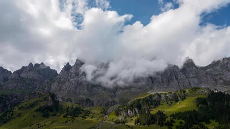 Panoramic-timelapse-of-grey-mountains-above-grassy-green-hills-in-Alps-of-Urnerboden-Klausenpass-Switzerland