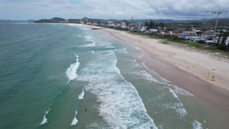 Drone-Flying-Over-Lifesavers-In-Palm-Beach---Gold-Coast---Queensland-QLD---Australia---Drone-Shot