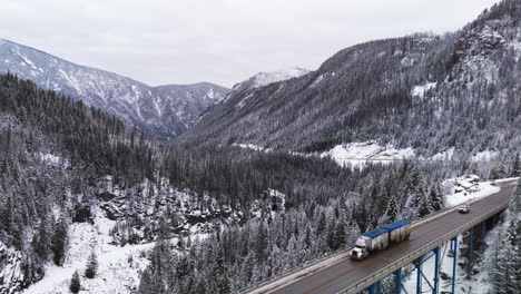 Semi-Trucks-crossing-Mountains-Guard-Paulson-Bridge-in-Winter's-Majesty