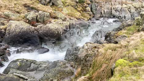 Heavy-flowing-clear-water-stream-during-winter-in-Lake-District---Cumbria,-UK