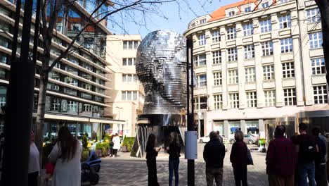 Tourists-admiring-the-Franz-Kafka-Rotating-Head-sculpture-in-Prague