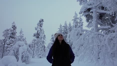 Girl-Explores-Beautiful-Scenery-In-Snowy-Forest-In-Lapland,-Finland,-Arctic-Circle