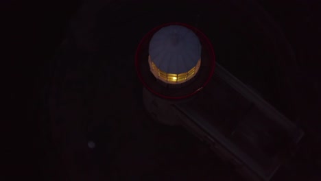 Rotating-top-down-view-of-a-lighthouse-at-night
