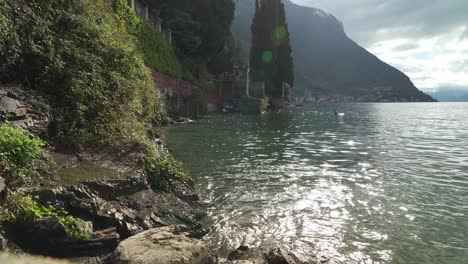Water-Splashes-Against-Rocky-Coast-of-Town-Varenna-in-lake-Como