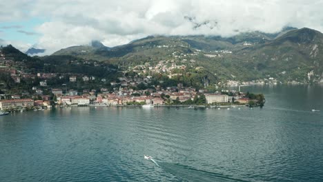 AERIAL:-Motor-Boat-Sails-to-port-of-Menaggio-Town-in-lake-Como
