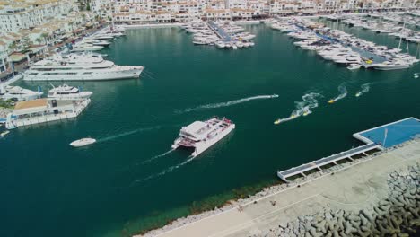Luxury-yachts-docked-in-puerto-banus-marina-in-marbella,-spain,-aerial-view