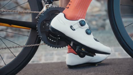 a-male-cyclist-preparing-for-a-ride-and-clipping-his-shoe-into-the-pedal