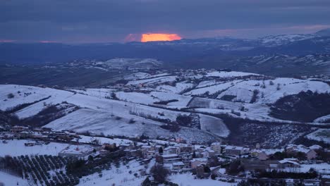 Sunset-view-of-snow-covered-hills-and-villages-from-Guardiagrele,-Abruzzo,-Italy