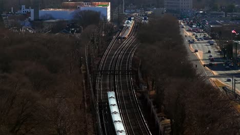 An-aerial-view-of-a-Long-Island-Rail-Road-train,-heading-to-the-next-station-on-a-sunny-day