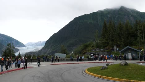 Tourists-visiting-Mendenhall-Glacier-and-Bullard-Mountain,-as-seen-from-the-Mendenhall-Glacier-Visitor-Center,-Tongass-National-Forest-Alaska