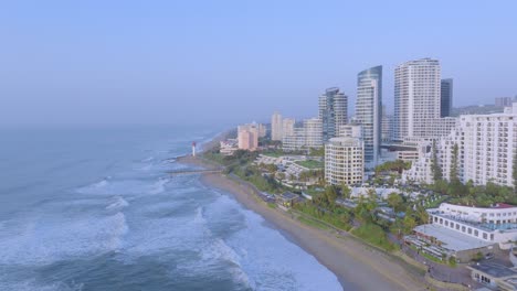Umhlanga-coastline-in-durban-with-modern-buildings-and-lighthouse,-daytime,-aerial-view