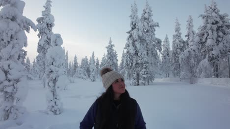Girl-Exploring-Snow-Covered-Forest-In-Lapland,-Finland,-Arctic-Circle