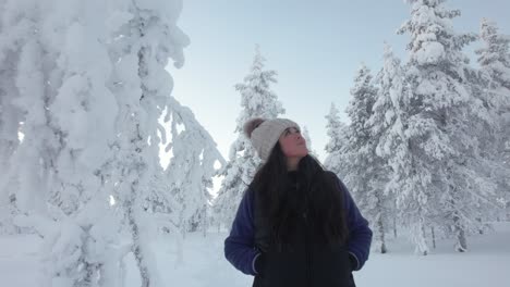 Beautiful-Girl-Exploring-Scenery-In-Snowy-Forest-In-Lapland,-Finland,-Arctic-Circle