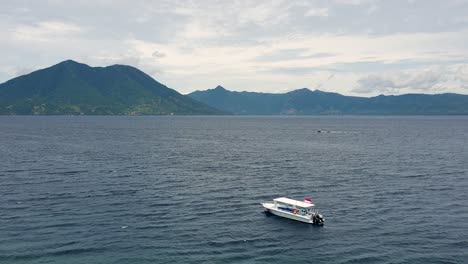 Ocean-view-on-Alor-Island-of-eastern-Lesser-Sunda-Islands-with-a-dive-boat-against-volcanic-tropical-island-in-East-Nusa-Tenggara