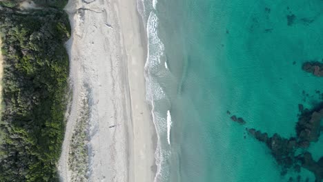 Cinematic-Topdown-Drone-Shot-from-Beach-and-Waves