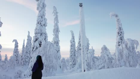 Girl-Takes-A-Stroll-and-Explores-Beautiful-Snow-Covered-Winter-Wonderland-in-Lapland,-Finland,-Arctic-Circle