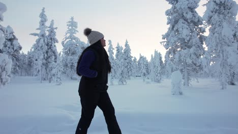 Girl-Exploring-Scenic-Landscape-In-Snowy-Forest-In-Lapland,-Finland,-Arctic-Circle