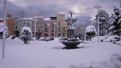 View-of-a-water-fountain-in-Guardiagrele-in-winter-with-snow,-Abruzzo,-Italy