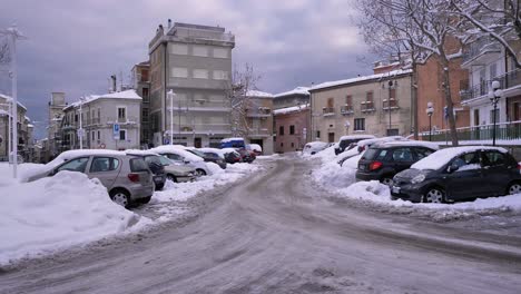 Open-town-square-and-streets-of-Guardiagrele-under-snow-in-winter,-Abruzzo,-Italy