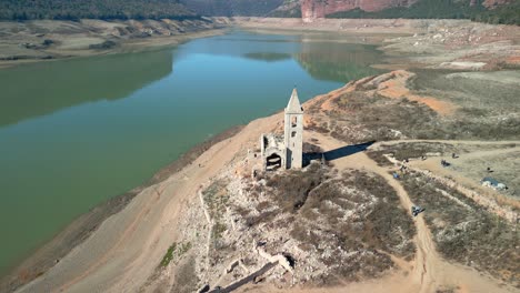 Sau-swamp-dike-in-Catalonia,-Spain,-intense-drought-in-2024-church-completely-out-of-the-water