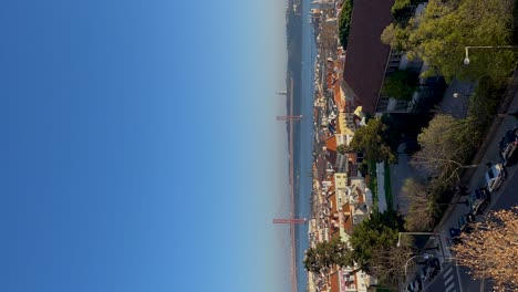 aerial-vertical-view-over-the-Tagus-river,-the-25-april-bridge-and-Lisbon,-Portugal