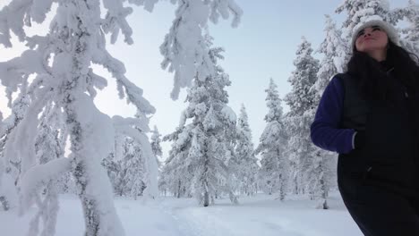 Girl-Exploring-Beautiful-Scenery-In-Snowy-Forest-In-Lapland,-Finland,-Arctic-Circle