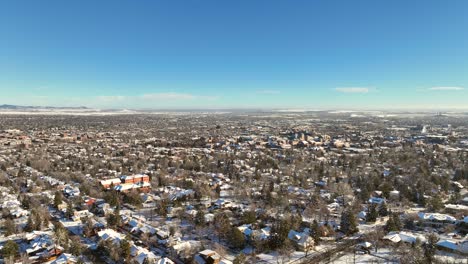 Town-of-Boulder,-Colorado-Aerial-Drone-video-after-a-snow-storm-on-a-clear-morning-with-University-of-Colorado-Boulder-in-the-background