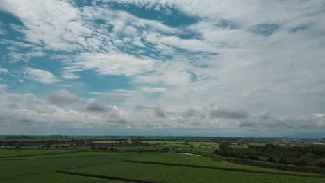 Aerial-Hyperlapse-Over-Sugar-Cane-Crops-With-Clouds-Moving-in-Valle-del-Cauca-Colombia