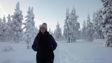 Girl-Exploring-Snowy-Forest-In-Lapland,-Finland,-Arctic-Circle