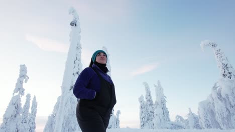 Girl-Walks-and-Explores-Beautiful-Snow-Covered-Winter-Wonderland-in-Lapland,-Finland,-Arctic-Circle