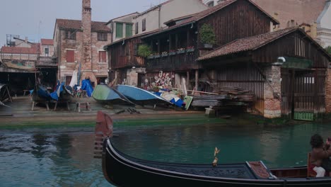 Tourists-exploring-Venice-on-gondola-tour-at-Squero-di-San-Trovaso