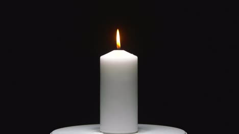 A-serene-candle-flame-against-a-black-backdrop,-perfect-for-chroma-key