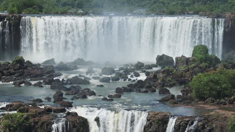 Rocky-Plunge-Pool-Eroding-From-Rough-Crashing-Waterfall,-Wide-Aggressive-Waterfalls-Hitting-Rocks-Flowing-in-Beautiful-Rainforest-Hidden-in-the-Jungle-in-Iguazu-Falls,-Brazil,-South-America