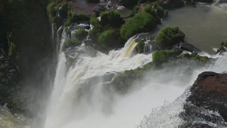 Amazing-Clear-Water-Pouring-off,-Falling-Deep-into-Argentinian-Rainforest,-Lots-of-Nature-Covered-in-Rough-Beautiful-Waterfall-Current-Running-Down-Steep-Rocky-Cliff-in-Iguacu-Falls,-South-America