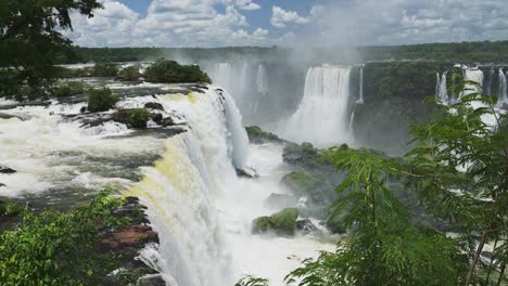 Iguazu-Falls-Waterfall-in-Brazil,-Huge-Waterfall-Valley-Hidden-in-Large-Green-Jungle,-Amazing-Nature-Scenery-of-Waterfalls-Falling-on-Green-Coloured-Rocky-Floor-in-Iguacu-Falls,-South-America