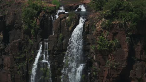 Amazing-Dramatic-Stream-Falling-Down-Steep-Rocky-Cliff-in-Beautiful-Jungle-Enviornment,-Waterfalls-Seeping-Through-Rough-Terrain-in-Holiday-Destination-in-Iguazu-Falls,-Brazil,-South-America