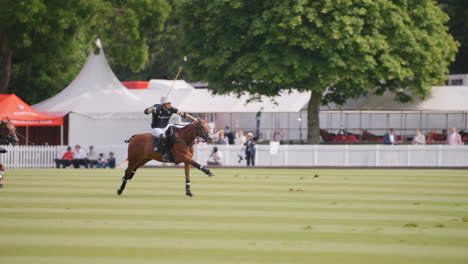 Polo-player-gallops-towards-the-ball-and-hits-it,-he-is-chased-down-by-the-opposing-team