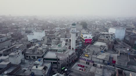 Aerial-Drone-Shot-of-a-Mosque-Tower-in-Gujrat-in-Pakistan-on-a-foggy-day