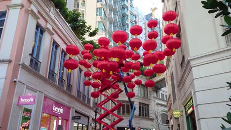 Low-angle-shot-of-Chinese-New-Year-Lanters-hanging-on-Lee-Tung-street-under-cloudy-sky-in-Wan-Chai,-China