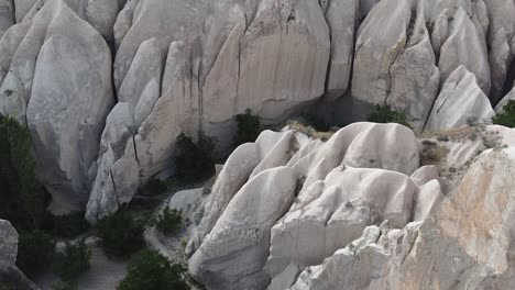 Drone-flying-over-the-natural-rock-formations-of-Cappadocia,-a-historical-tourist-destination-located-in-Central-Anatolia-in-Turkey