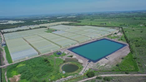 Irrigation-Basin-Next-To-Greenhouses-On-Agricultural-Field-In-Kenya