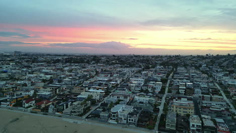 Panoramic-view-of-Los-Angeles-and-sandy-beach-during-sunrise,-aerial