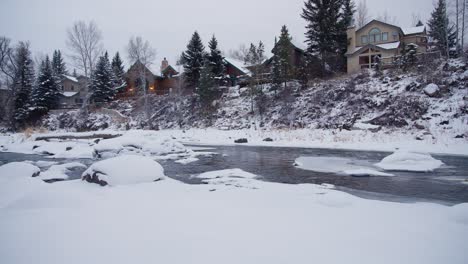 Christmas-Day-in-Mountains-of-Colorado-USA,-Homes,-Creek,-Pine-Trees-and-Snow-Capped-Landscape