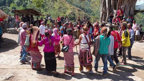 Group-of-Timorese-men-and-women-wearing-cultural-clothes-attire-and-performing-a-traditional-dance-at-welcome-ceremony-in-East-Timor,-Southeast-Asia