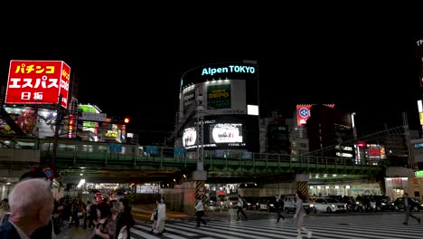 Metro-train-travels-over-Shinjuku-underpass-vibrant-neon-lit-night-commute-scene